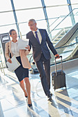 Business people pulling suitcase