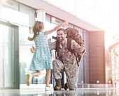 Daughter running and greeting soldier father
