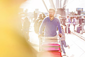 Man pushing luggage cart outside airport
