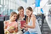 Mother and daughters using digital tablet