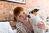 Smiling woman with Jack Russell Terrier dog