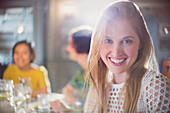 Portrait smiling woman dining with friends