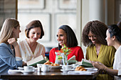 Women friends discussing book club book