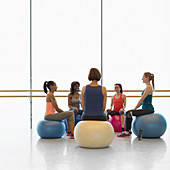 Women on fitness balls in circle
