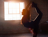 Silhouette female dancer stretching