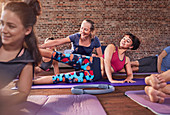 Fitness instructor adjusting young woman