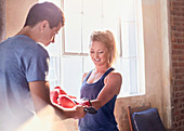 Trainer helping young female boxer