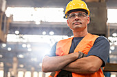 Portrait serious confident steel worker in factory