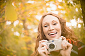 Portrait enthusiastic woman with digital camera