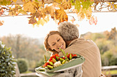 Husband surprising wife with flower bouquet