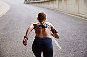 Fit female runner running on urban street