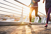 Runner couple running at sunrise