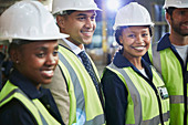 Portrait female worker with co-workers