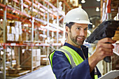 Worker using scanner in distribution warehouse