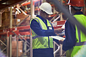 Workers with clipboards meeting