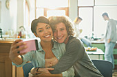 Smiling affectionate young couple taking selfie