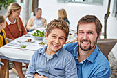 Father and son enjoying patio lunch