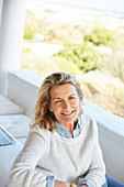 Portrait smiling senior woman on patio