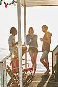 Friends hanging out on sunny summer houseboat