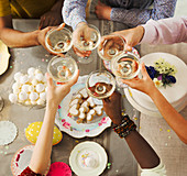 Friends toasting over Easter desserts