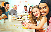 Mother and daughter hugging at birthday party