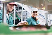 Portrait smiling female worker inspecting apples