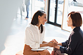 Businesswomen holding hands