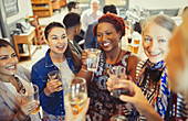 Women friends toasting wine and beer glasses