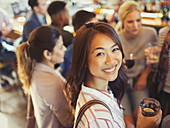 Portrait Woman drinking with friends at bar