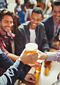 Waiter handing beer to man at bar