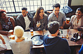 Friends drinking beer and wine in bar