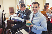 Businessman drinking coffee and using laptop