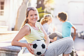 Portrait Woman holding soccer ball