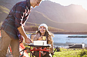 Young couple camping, cooking