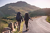 Young couple with backpacks hiking
