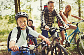 Portrait girl mountain biking with family