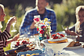 Family enjoying strawberry cake