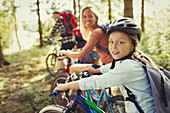 Portrait mother and daughter mountain biking