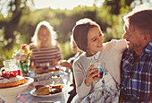 Father and daughter enjoying garden party