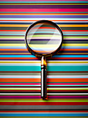 Magnifying glass on striped background