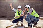 Construction worker and engineer talking