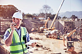 Construction worker talking on walkie-talkie