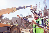 Construction worker with tablet guiding equipment