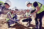 Construction workers and engineers using tablets