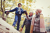 Grandparents walking grandson on log