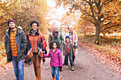 Family walking on path in autumn park