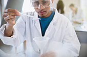 Male college student using pipette