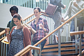 College students with coffee descending stairway