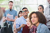 College students listening and taking notes