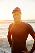 Portrait male triathlete swimmer in ocean surf